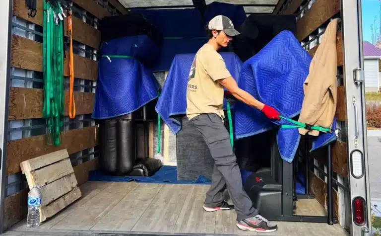A man loading a moving truck with boxes, following a Step-by-Step Guide for a Stress-Free Move.