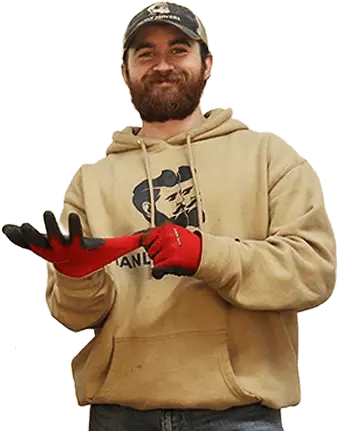 A man in a hoodie holding a pair of gloves.